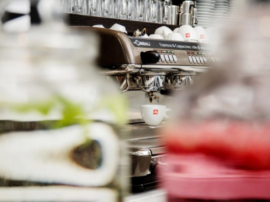 Unscharfe Espressomaschine mit Tassen an einer Café-Theke